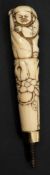 A Japanese carved ivory parasol handle: the handle depicting Daikoku,