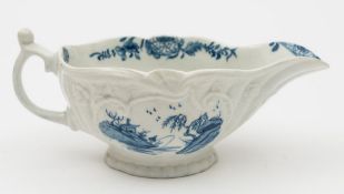 A Worcester blue and white sauceboat: of silver shape with scroll handle and thumbrest,