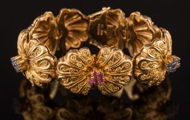 A sapphire and ruby mounted bracelet: of scalloped linking with applied rope-twist wirework and