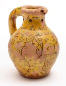 A Donyatt pottery puzzle jug: of typical bellied form with pierced neck and hollow rim and handle,