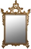 A carved giltwood marginal wall mirror:, with pierced rococco scroll, acanthus,