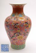 A Chinese famille rose porcelain baluster vase: decorated with scrolling flowers and foliage on a