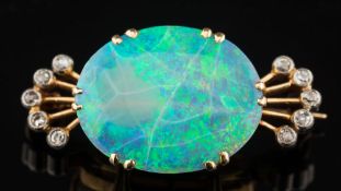 An opal and diamond brooch: with central oval opal 19mm long x 15mm wide claw-set between
