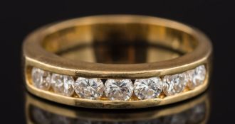 An 18ct yellow gold and diamond seven stone half eternity ring: with circular brilliant-cut