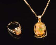 A yellow metal and irregular jelly opal,