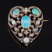 An opal and diamond mounted heart-shaped pendant brooch: of openwork design,