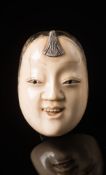 A Japanese carved ivory netsuke: Meiji period (1864-1912) of Mambi's mask (see Davey p.