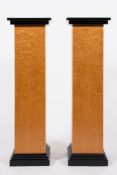 A pair of Art Deco burr maple veneered and ebonised square pedestals: raised on stepped plinth