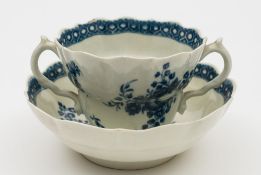 A Worcester blue and white chocolate cup and saucer: of double ogee form with scroll handles,