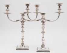 A pair of Elizabeth II silver twin branch candelabra, maker JCL,