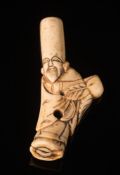 A Japanese stag horn netsuke: Meiji period (1864-1912) in the form of an Immortal, unsigned 8cm.
