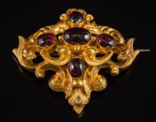 A mid 19th century gold and garnet brooch: of openwork foliate scroll design with five oval