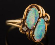 An opal two stone ring: the two irregular opals approximately 10mm and 11mm total length and