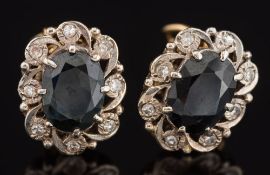 Pair of sapphire and diamond oval cluster earrings: each with an oval sapphire claw-set within a