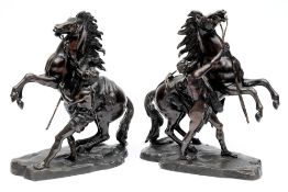 After Guillaume Cousteau, a pair of bronzes of the Marly Horses: each raised on a naturalistic base,