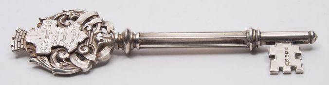 A George V silver presentation key, maker Marples & Beasley, Birmingham, 1911: inscribed, 13cm.