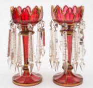 A pair of Bohemian ruby and gilt glass lustres: with petal shaped rims and fluted stems,