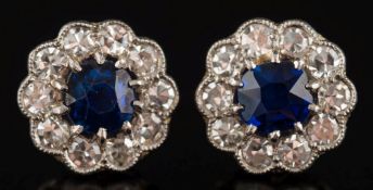 A pair of sapphire and diamond circular cluster ear studs: each set with a central,