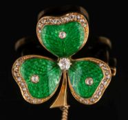 A green enamelled gold and diamond mounted three leaf 'clover' brooch: each leaf with a single,