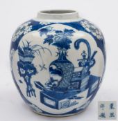 A Chinese blue and white ginger jar: painted with foliate panels of auspicious objects on a prunus