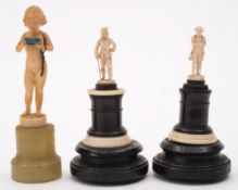 A carved ivory miniature figure of a young girl: carrying a box in her hands,