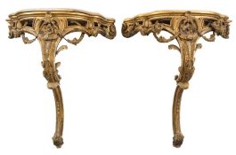 A pair of 19th Century carved giltwood and gesso console tables:, of serpentine fronted outline,