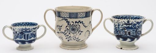 A group of three blue and white pearlware loving cups: two attributed to the 'Boulder and Fence'