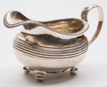 A George IV silver cream jug, maker's mark worn, London, 1825: inscribed, of barge-shaped outline,
