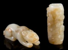 Two Chinese pale celadon jade carvings: one in the form of a crouching mythical beast,