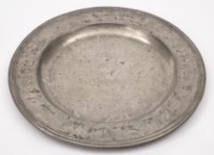 An 18th century pewter charger: of plain circular form with a moulded edge,