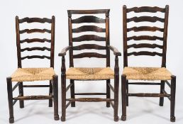 A harlequin set of ten early 19th Century elm and ash shaped ladderback dining chairs:,