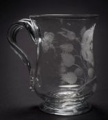 A mid 18th century glass baluster mug: of possible Jacobite significance, with ribbed strap handle,