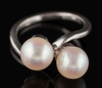 A platinum and cultured pearl crossover ring: the cultured pearls, each approximately 7.