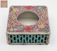 A Chinese porcelain stand: of square form with reticulated sides, the top with circular opening,