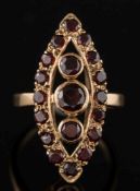 A 9ct gold and garnet marquise shaped cluster ring: with graduated circular-cut garnets,