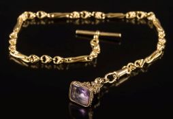 An 18ct gold watch chain with circular and elongated links, attached T-bar and gold plated,