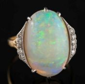 An 18ct gold, opal and diamond ring: with central oval opal 19.2mm long x 13.