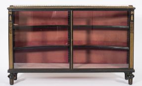 A Victorian ebonised and gilt brass and metal mounted low display cabinet:, with a concave back,