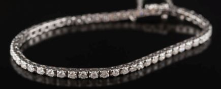 A diamond mounted line bracelet: with 54 round brilliant-cut diamonds estimated to weigh a total of