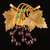 A garnet and turquoise mounted vine leaf brooch:.