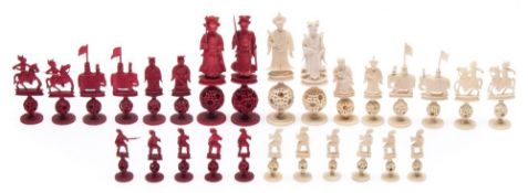 A Chinese carved ivory Mandarin part chess set: one side stained red the other side left natural,