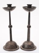 A pair of WMF Art Nouveau period alloy candlesticks: with plain cylindrical nozzles and cupped drip
