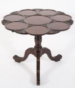 A 19th century carved mahogany circular supper table:,