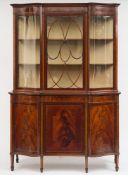 An Edwardian mahogany and inlaid display cabinet: of shaped front outline, crossbanded in satinwood,