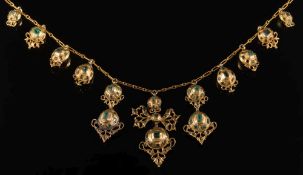 Eleven antique gold and emerald mounted drops mounted as a necklace: the graduated drops with