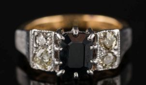 A sapphire and diamond five-stone ring: the rectangular sapphire between pairs of circular,