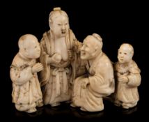 A small Japanese carved ivory okimono: of a family group depicting Lady Tang breast-feeding her