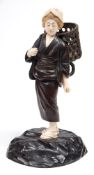 A Japanese bronze and ivory okimono, of a peasant girl: carrying a large basket on her back,