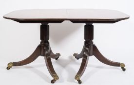 A late 19th century mahogany D-end three pillar dining table in the Regency taste:,
