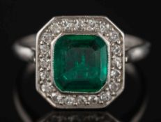 An Art Deco emerald and diamond rectangular cluster ring: the central emerald approximately 8mm